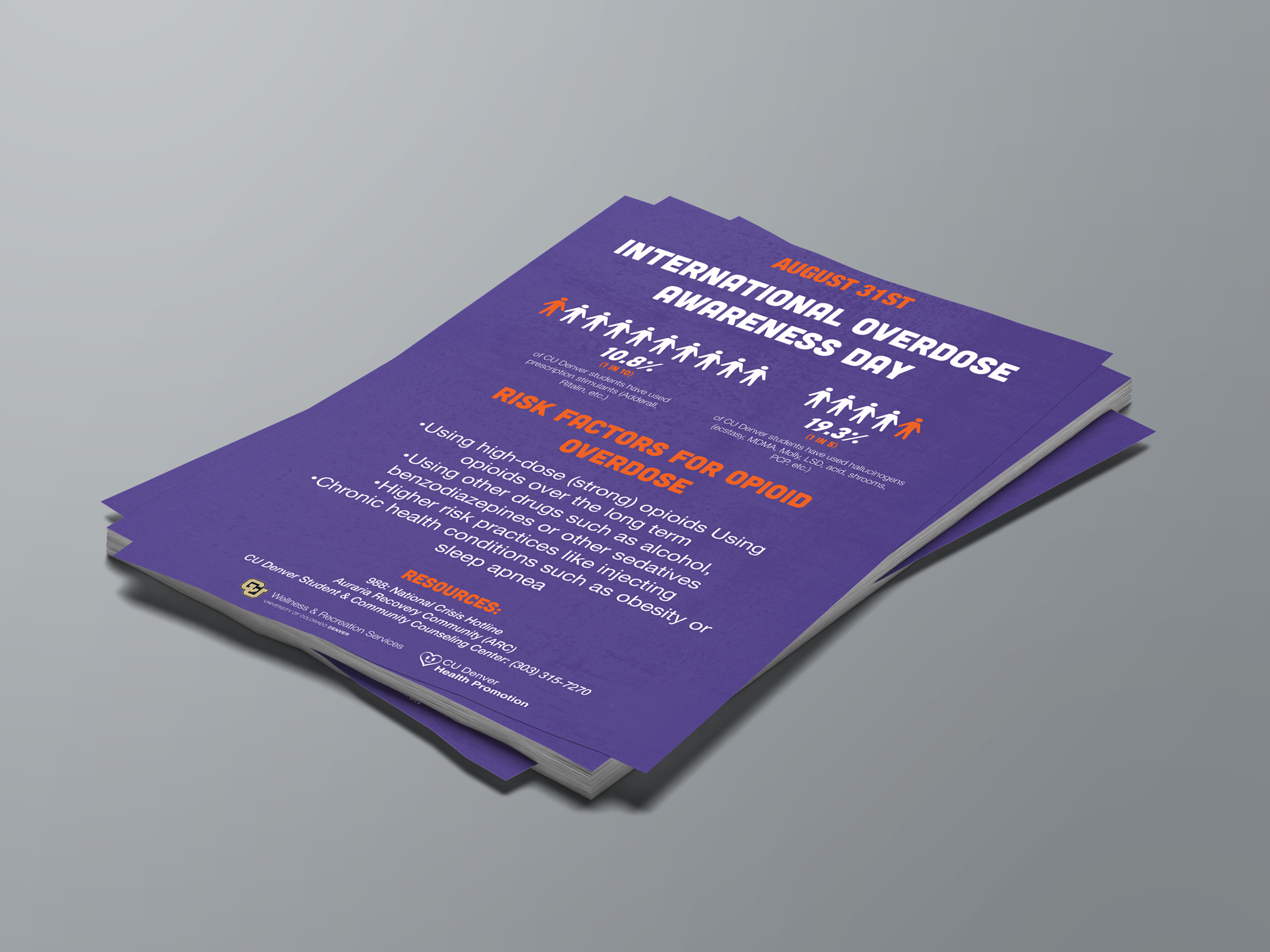 A stack of purple flyers for International Overdose Awareness Day, featuring white and orange typography with an infographic showing the percentage of students affected by opioid use.