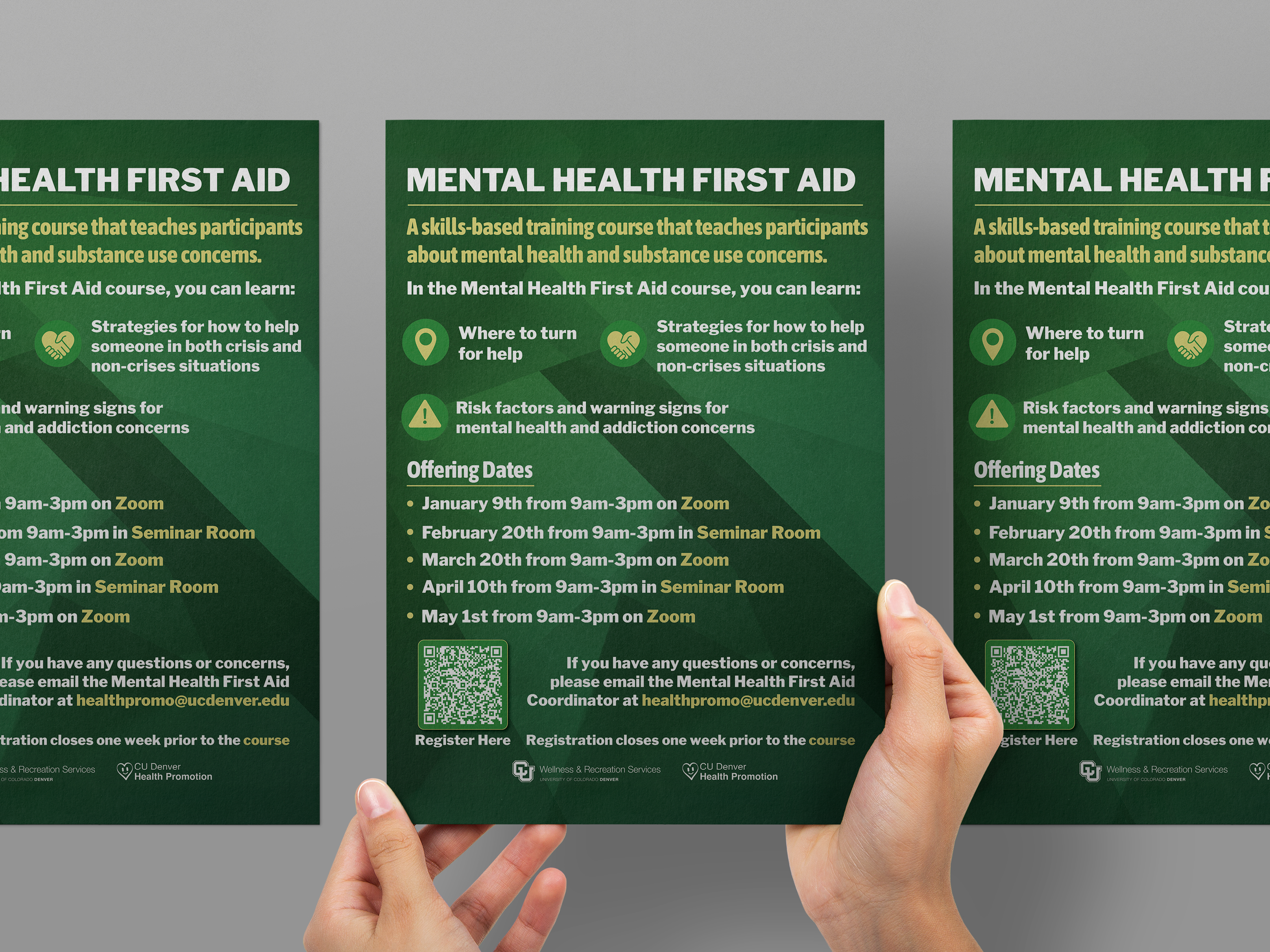 Hands holding a green flyer for a Mental Health First Aid course, displaying a list of offering dates and course learning objectives.
